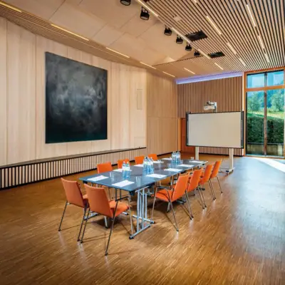 Conference room A room with a table and chairs.