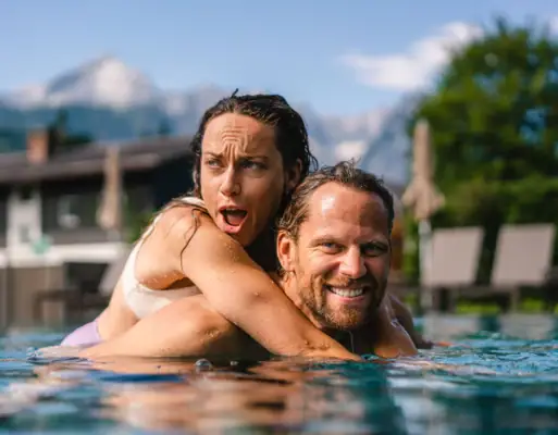 Couple in the pool A man and a woman in the pool, smiling.