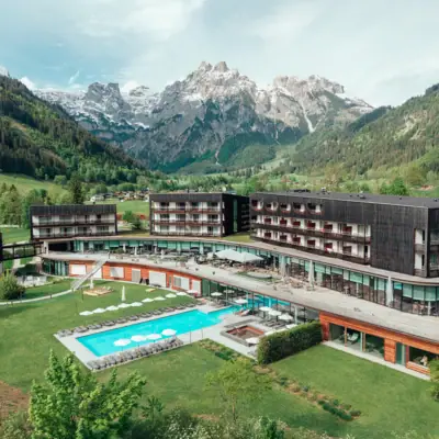 aja Werfenweng Mountain Resort A hotel with a swimming pool and mountains in the background